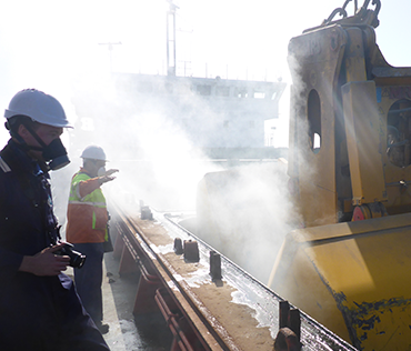 Boat fire being doused by tugs